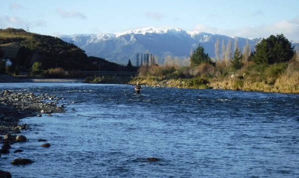 An angler fishing the very top of Veras with the distant hills providing a stunning winter background.