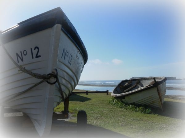A couple of Norfolk Island boats called lighters used to bring ashore supplies and passengers from ships waiting outside the reef.