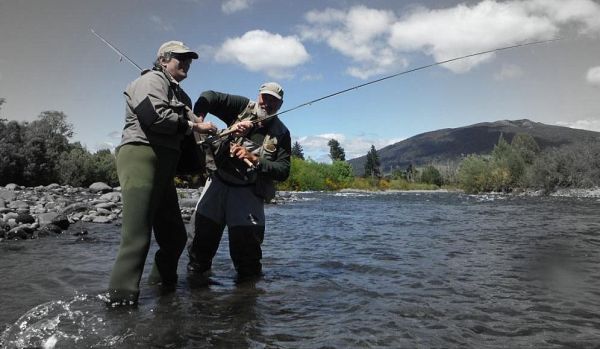 Stan playing his first New Zealand trout while Leon gives some advice...this one took a white caddis.